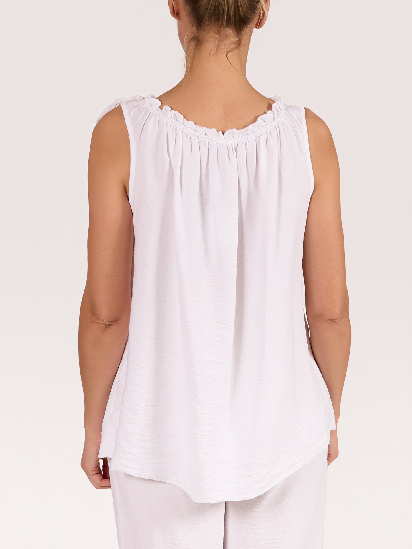 White Sleeveless Top with Ruffled Neckline and Side Tie