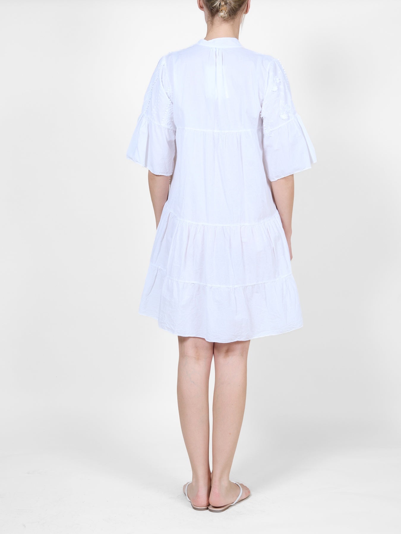 White Dress with Ruffle Details and Floral Embroidery