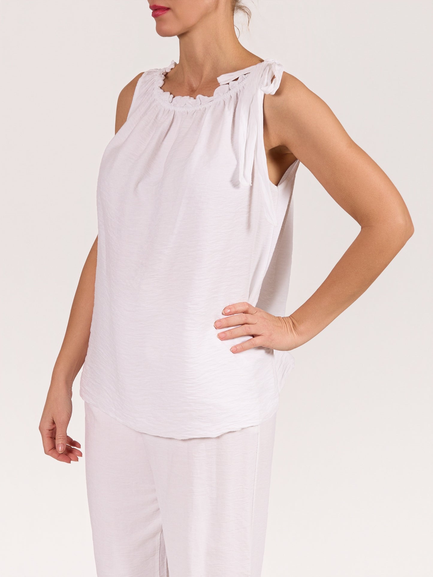 White Sleeveless Top with Ruffled Neckline and Side Tie