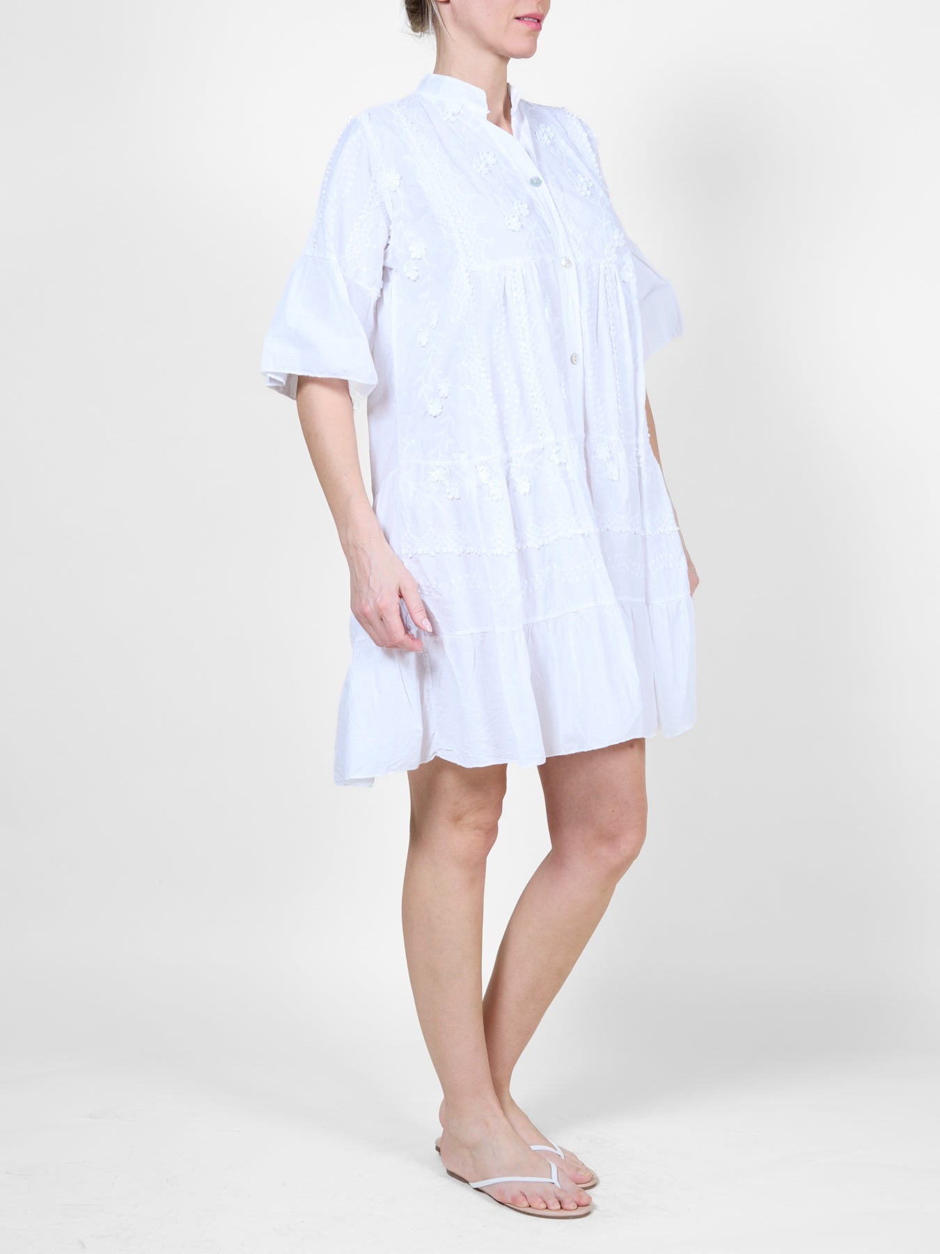 White Dress with Ruffle Details and Floral Embroidery